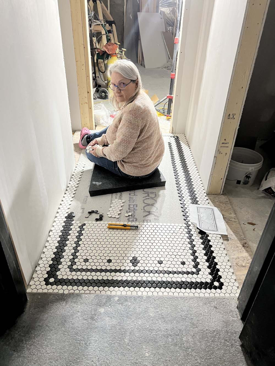 Tiling floor in process - &copy;Lydia Charak